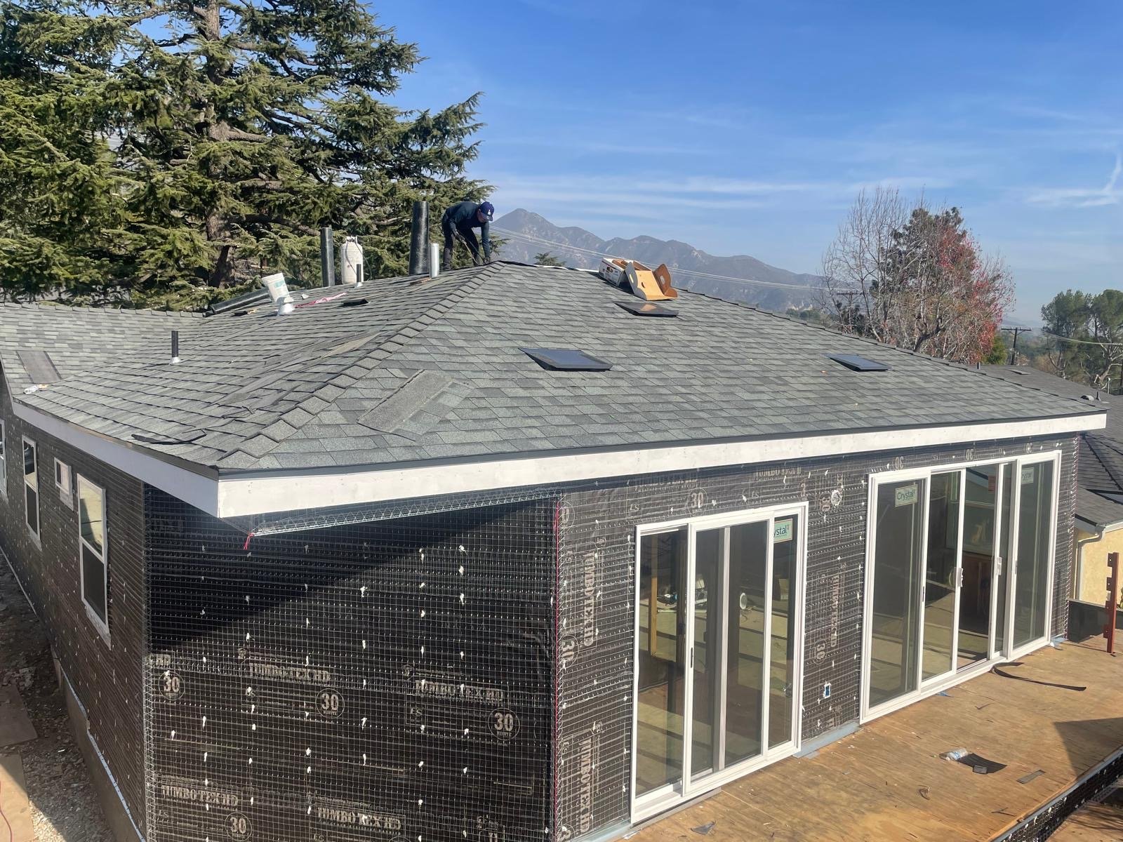 Finished architectural shingle roof with mountain backdrop