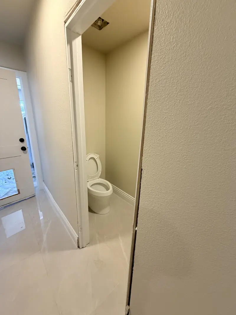 Finished bathroom with marble tile floor
